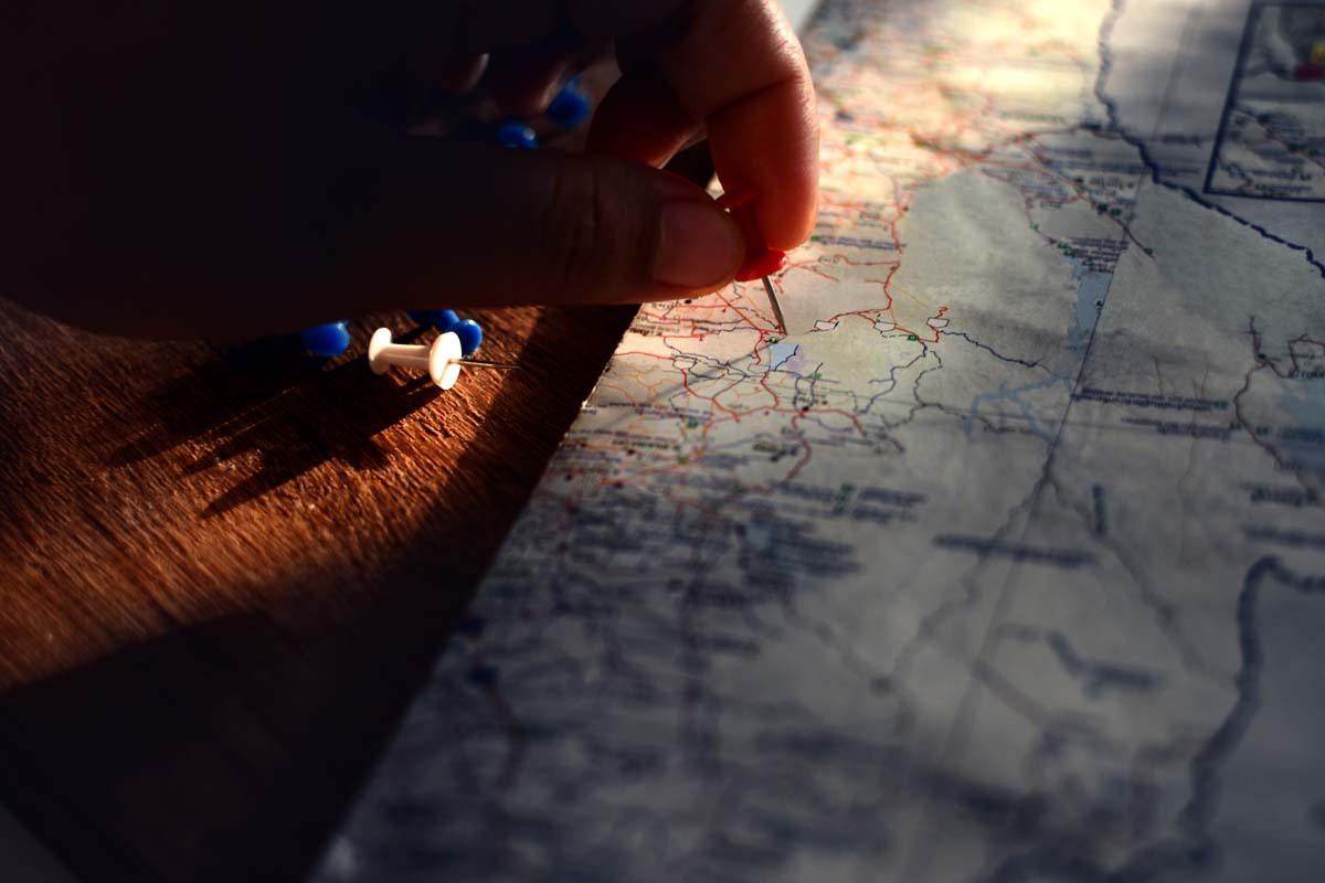 hand pinning a map