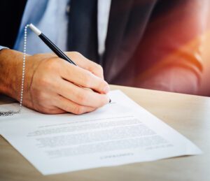 man signing paperwork